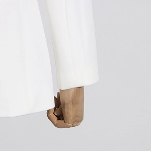 Detail shot of white blazer cuff showing premium smooth fabric and precise stitching