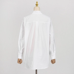 Detailed back view of white rhinestones shirt with a box pleat and drop shoulder design