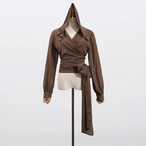 Detail of deep brown hooded wrap shirt with cross V-neck design and waist tie