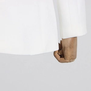 Detail view of white blazer sleeve and hem stitching on professional dress jacket