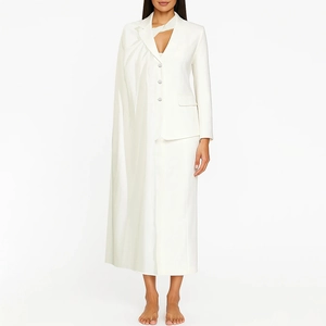 Detail of white fashion suit jacket featuring unique one-side shawl design and pearl buttons