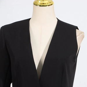 Detail of black deep V-neck collarless blazer with matte texture on a mannequin
