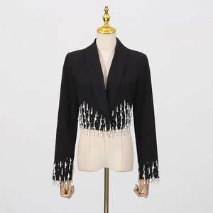 Detailed view of black cropped blazer featuring intricate white sequin tassel fringe hem