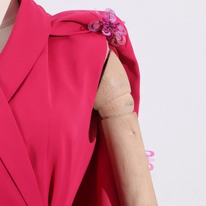 Close-up of fuchsia blazer with delicate 3D floral sequins on shoulder detail
