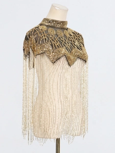 Elegant gold beaded capelet with sequins and long tassel fringes on a white background