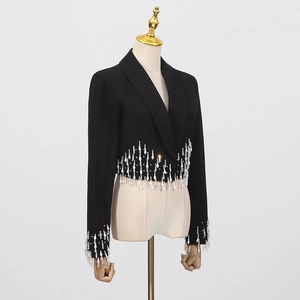 Detailed view of rhinestone fringe droplets on cuffs of a black short blazer jacket