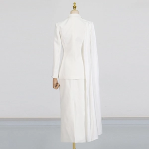 Detailed back view of white suit with long pleated shawl and elegant maxi skirt
