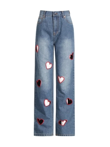 High waist straight jeans in blue denim featuring creative red heart cut-out patterns
