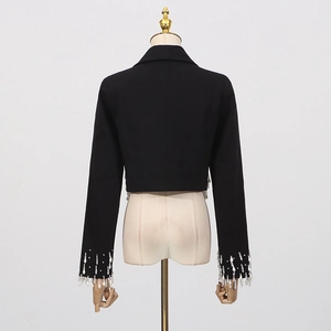 Rear view detail of black cropped blazer featuring sparkling rhinestone fringe on hem and cuffs