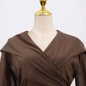Detail of elegant dark brown chiffon wrap top with deep V-neck and broad lapels