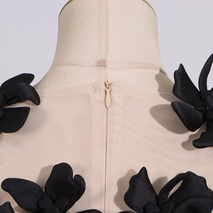 Detail of the back neck area with black floral lace appliques and invisible zipper