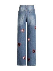 Women's light blue straight leg jeans with red heart cutouts on the back view