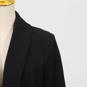 Detail of rhinestone stitching and shoulder seam on this black women's blazer jacket
