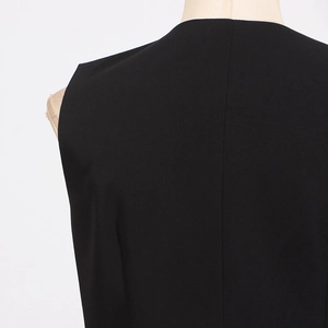 Detail of black street style waistcoat showing collar stitching and woven fabric texture