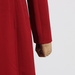 Vue détaillée du poignet rouge à manches longues et de la texture mate du tissu du manteau