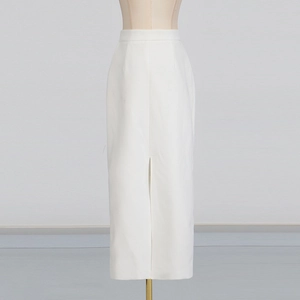 Detail of white high-waisted maxi skirt with side slit on mannequin for spring