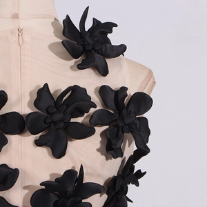 Detail view of 3D floral appliques and invisible zipper on mesh fabric top