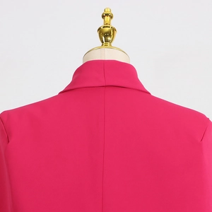 Detail view of the rose red blazer back with structured collar on a gold mannequin stand