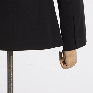 Detailed close-up of high-quality black blazer fabric with precise stitching details