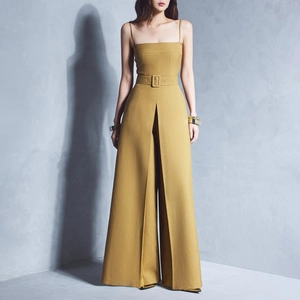 Detail of waist belt and wide leg pleats on mustard yellow jumpsuit for women