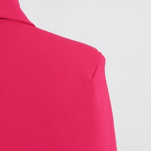 Macro detail of magenta blazer shoulder with premium stitching and fine fabric texture