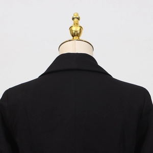 Close-up of the back collar and shoulder stitching on a tailored black blazer jacket