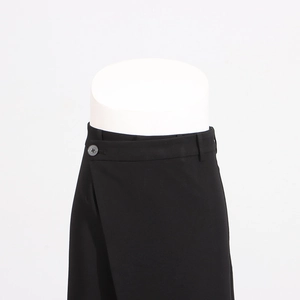 Detail of high waist wrap trousers with dark gray button and smooth premium fabric