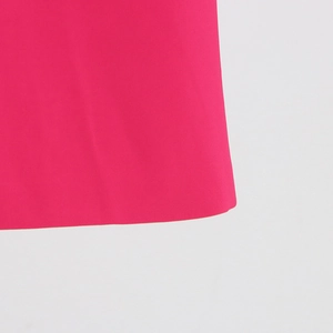 Detail of rose pink fabric texture and high-quality stitching on a women's blazer