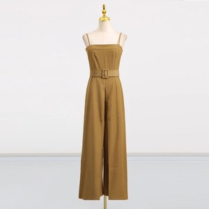 Detail of tan sleeveless jumpsuit with a square buckle belt and wide leg cut