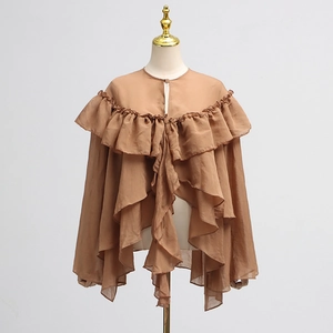 Detailed view of layered ruffles and sheer mesh stitching on this brown chiffon blouse
