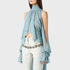 Detail of light blue halter chiffon blouse with ruffled sleeves and rose chain belt