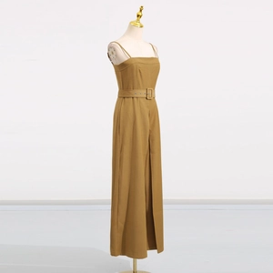Detail of high-waist jumpsuits with square buckle belt and slim fit wide leg cut