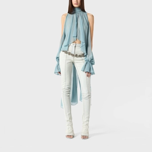 Detail of sky blue halter top with tiered ruffles and elegant silver flower waist chain