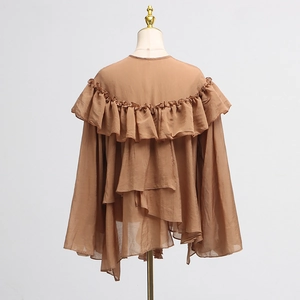 Rear view of brown ruffles blouse with mesh panel and layered asymmetrical hem details