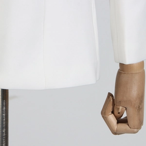 Detail of white blazer sleeve cuffs and clean hem stitching with high-quality fabric texture