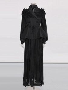 Elegant black two-piece set featuring a double-breasted ruffled top and pleated maxi skirt