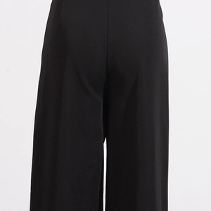 Detail shot of the high waist back fit and smooth fabric of these black wide-leg trousers