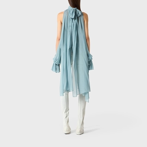 Detail of the ice blue halter top with a large decorative bow and flowing fabric back