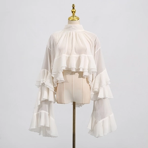 Detail view of the multi-layered ruffle trim and sheer white chiffon on a vintage blouse