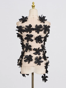 Chic sleeveless mesh top featuring 3D black fabric flowers on a beige sheer background