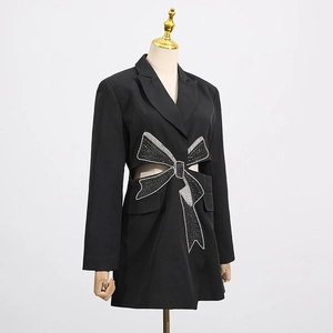 Detail shot of black waist cutout blazer dress with sparkling sequin bow decoration