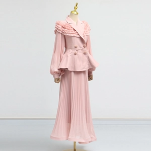 Detail of pink two-piece set with ruffle trim blazer and pleated maxi skirt on mannequin