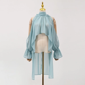 Detail of light blue chiffon top featuring a high neck and elegant ruffled layered sleeves