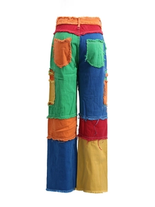 High-waisted wide leg jeans with colorful patchwork design and raw edge stitching detail