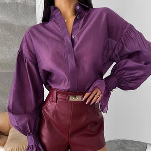 Detail of purple lantern sleeves and smooth sheer fabric on a stylish women's shirt