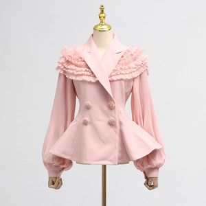 Detailed view of pink double-breasted peplum top with pleated sleeves and ruffled layers