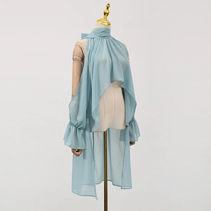 Detailed view of light blue chiffon halter top with pleated neckline and irregular hem