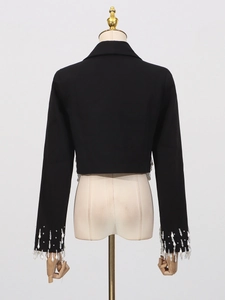 Back view of a cropped black blazer for women featuring pearl fringe tassels on the hem