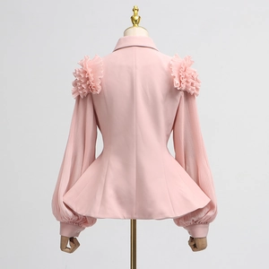 Close-up of pink slim fit blazer with layered ruffle shoulders and lantern sleeves