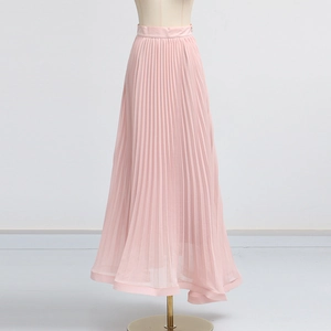Detail of light pink pleated chiffon maxi skirt showing high waist design and fine fabric